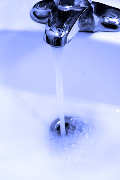 istock Sink Faucet Water Flowing Down Drain 1409494051