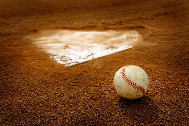 istock Old Leather Baseball on Field by Home Plate or Base 1409494053