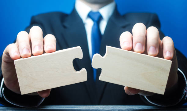 istock Businessman holds in hands two empty pieces of the puzzle. 1409494832