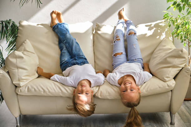 istock little girl and boy are lying on their backs on sofa 1409494968