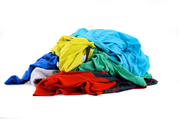 istock Pile of colorful dirty cloths for laundry isolated on white background 1409496607