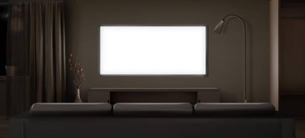 istock Wide lcd tv screen in dark living room at night 1409496947