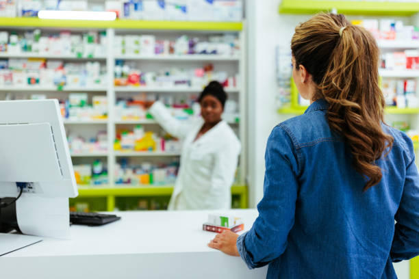 istock Pharmacist making drug recommendations in modern pharmacy 1409498434