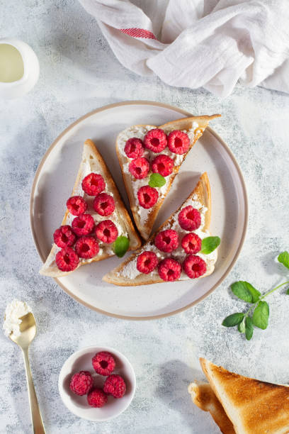 istock Crostini with cheese and raspberries, top view, vertical frame 1409499471