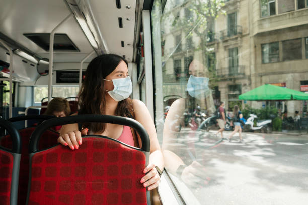 istock Woman with face mask on a bus 1409499700