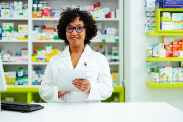 istock Happy pharmacist working at a drugstore 1409499976