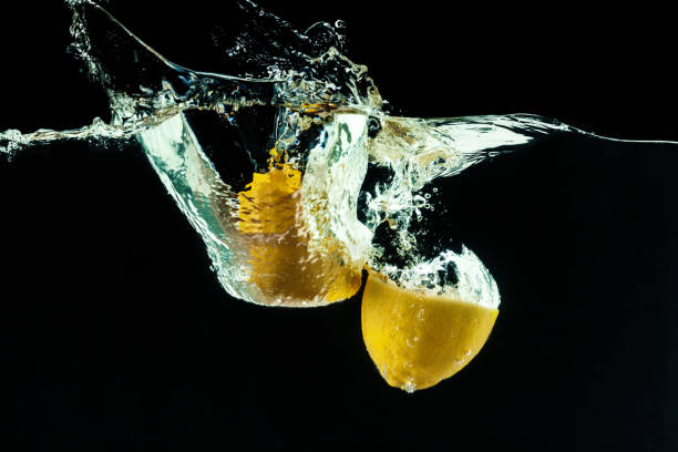 istock fresh yellow lemon in water splash on black background 1409501370