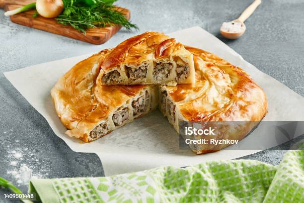 Classic Turkish Pie With Meat On Wooden Board Composition With Burek Pie On Concrete Background With Textile And Spices Balkan Pie With Minced Meat In Rustic Style On Gray Table Stock Photo - Download Image Now