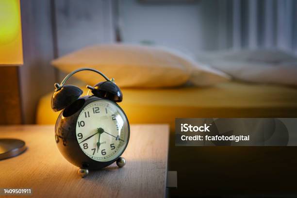 Alarm Clock On Night Table Stock Photo - Download Image Now - Alarm Clock, Sleeping, Bedroom