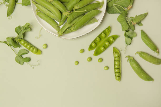 istock Freshly harvested organic green peas on the table 1409501970