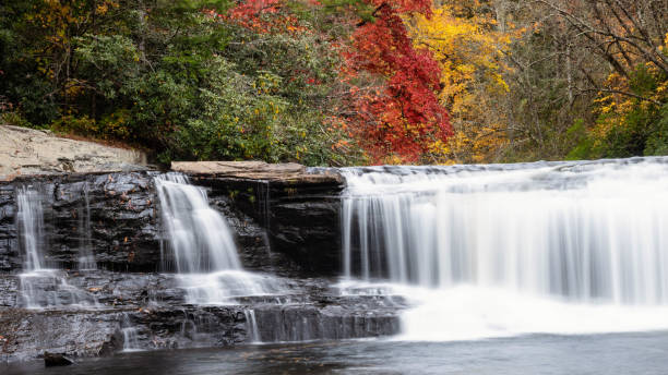 istock Refreshing Waterfall Hidden Deep in the Autumn Forest 1409502137