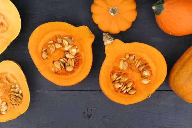 istock Cut pumpkins on black background. Top view. 1409502181