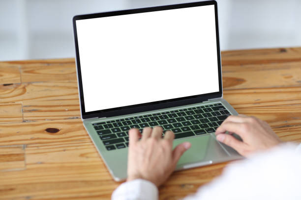 istock woman using and typing on laptop computer with blank white desktop screen on wooden table 1409502200