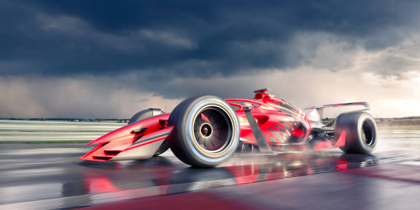 racing car moving at high speed on racetrack - damp course imagens e fotografias de stock