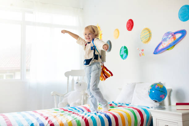 istock Kids play astronaut. Space and planet child game. 1409503162