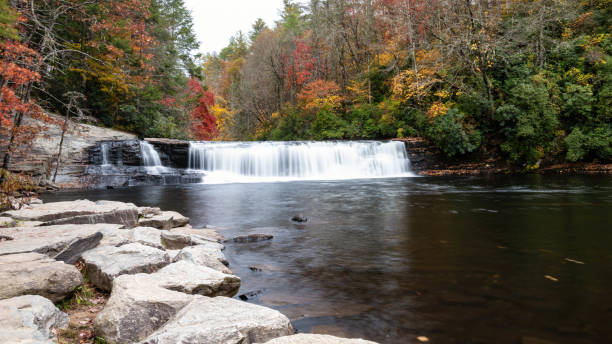 istock Refreshing Waterfall Hidden Deep in the Autumn Forest 1409503231