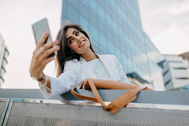 istock Smiling business woman taking selfie 1409504017