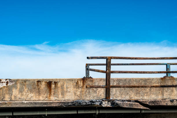 istock Damaged and bent guardrail along the edge of a bridge that needs repaired. 1409505593