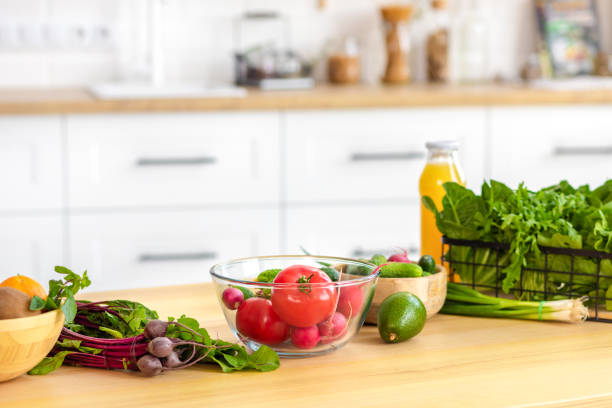istock Kitchen table with various fresh vegetables for healthy and diet food with space for your product or text 1409507177
