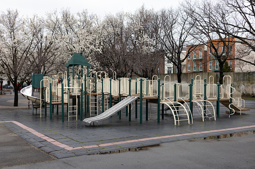 Hoyt Playground with no people during a rainy and wet spring day in Astoria Queens of New York City