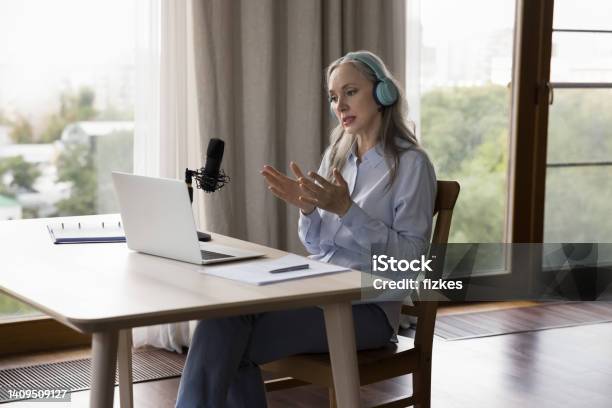 Serious Older Woman Holding Online Class Make Speech Into Mike Stock Photo - Download Image Now