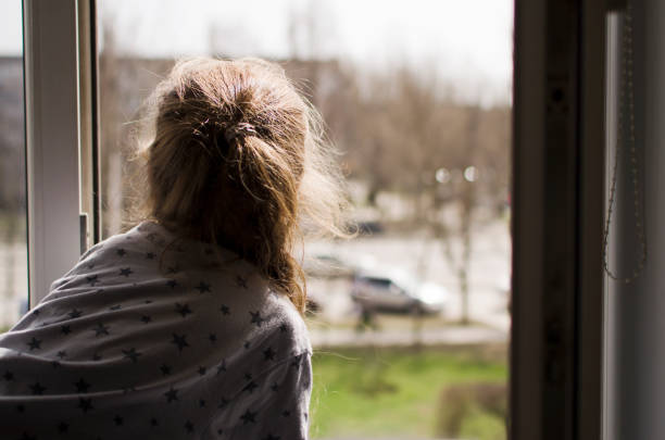 istock The child looks out the window 1409509476