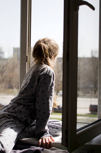 istock The child looks out the window 1409509479