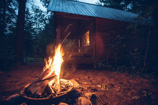 istock Campfire in front of a tiny house in the woods 1409510987