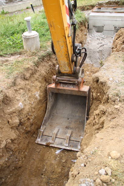 istock Excavator shovel digs into a loamy soil 1409511453