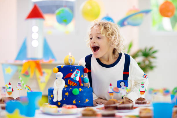 Kids space theme birthday party with cake.