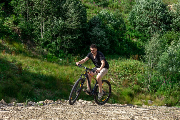 istock A man rides a bicycle in a mountainous area in the forest. 1409513598