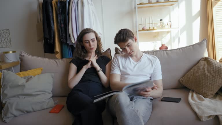 Woman tells funny stories watching school album with partner