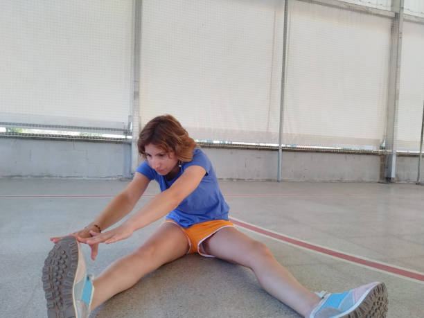 istock sporty girl doing leg stretching 1409515251