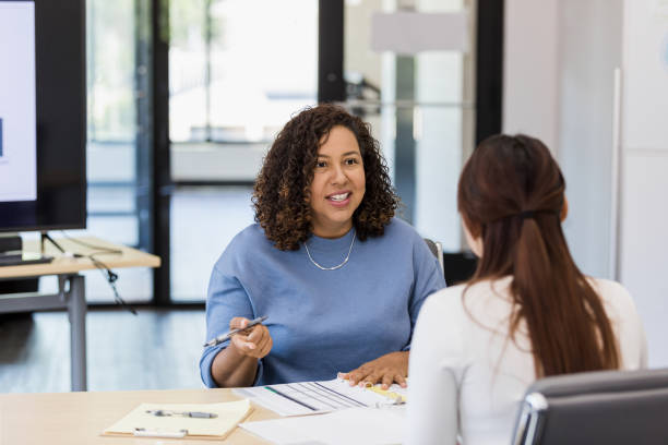 istock Female financial advisor meets with unrecognizable female client 1409517527