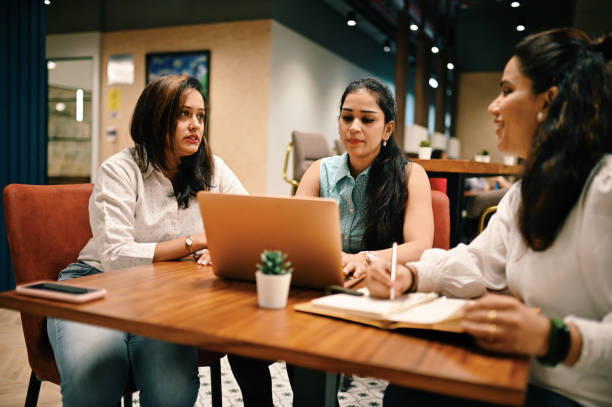 istock Group of women discussing in a co-working office 1409519727