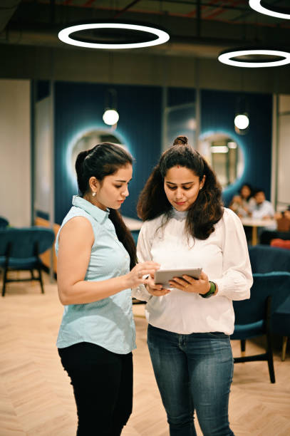 istock Two women standing and discussing in the co-working office 1409520277