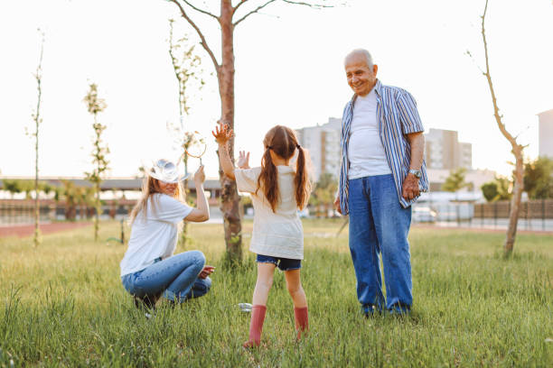 istock Happy family blowing soap bubbles in the park. 1409521123