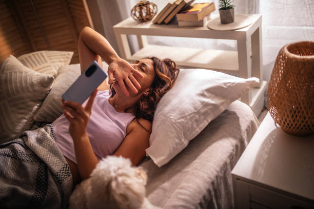 istock Women sleeping with her maltese puppy on bed 1409521941