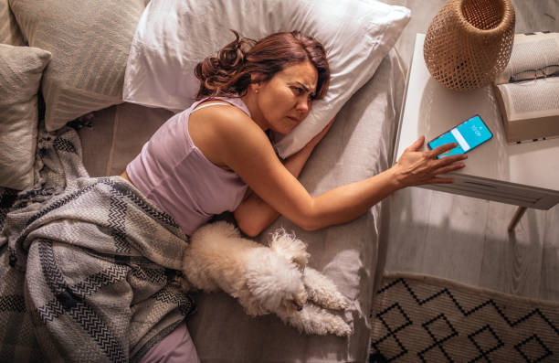 istock Women sleeping with her maltese puppy on bed 1409522129