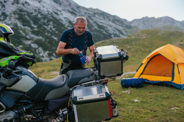 istock Biker assembling gass appliance on his bike 1409522297