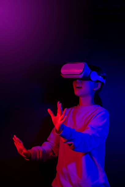 istock Teenager with Virtual Reality Glasses on a blue and red colored background. 1409522814