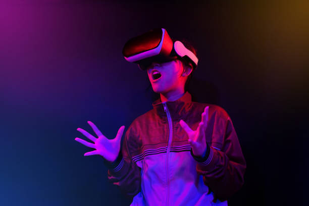 istock Teenager with Virtual Reality Glasses on a blue and red colored background. 1409522816