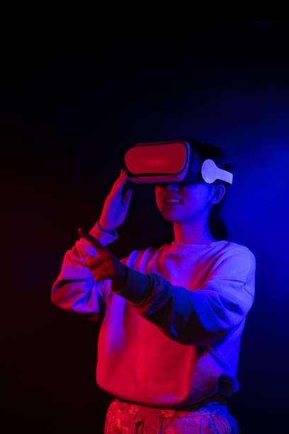 istock Teenager with Virtual Reality Glasses on a blue and red colored background. 1409522829