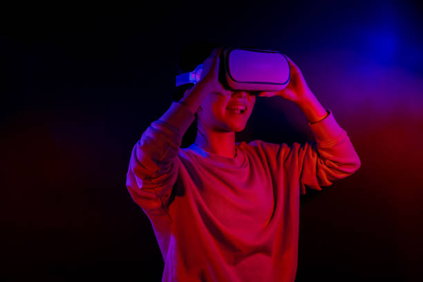 istock Teenager with Virtual Reality Glasses on a blue and red colored background. 1409522832