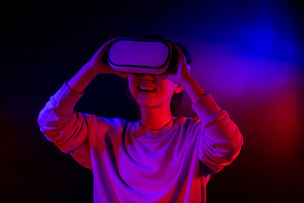 istock Teenager with Virtual Reality Glasses on a blue and red colored background. 1409522837