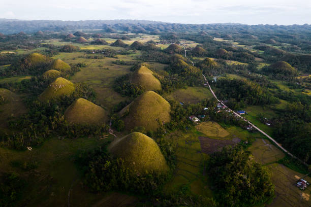 Stunning drone views of the famous Chocolate Hills mountain formations at sunset in Bohol, Philippines Incredible views of the chocolate hills mountains in bohol, philippines chocolate hills photos stock pictures, royalty-free photos & images