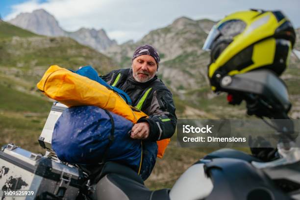Packing Stuff Its Time For Continuing Ride After Night Spent In Mountains Stock Photo - Download Image Now