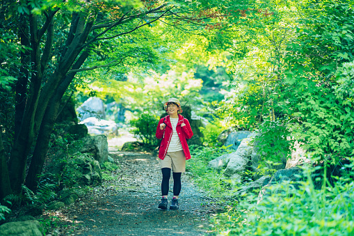 Young woman walking in the fresh green mountain