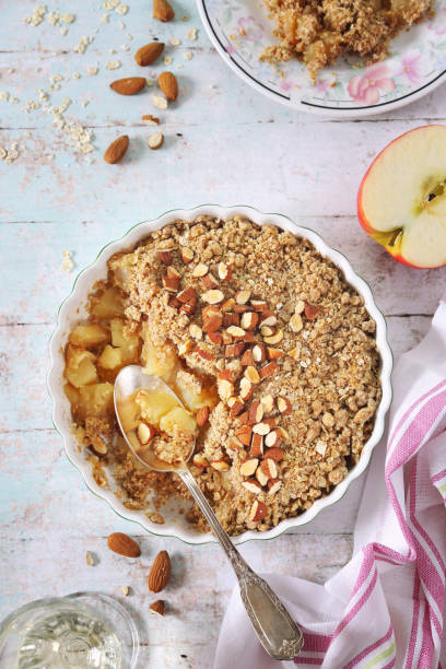 istock Fresh apple crumble from oatmeal, almondes dressing on light background 1409530451