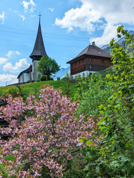 Small rustic chapel and chalet in springtime in the mountain village of Jaun near Bulle in Fribourg Canton above Gruyere in the Swiss Alps Switzerland Small rustic chapel and chalet in springtime in the mountain village of Jaun near Bulle in Fribourg Canton above Gruyere in the Swiss Alps Switzerland bulle stock pictures, royalty-free photos & images